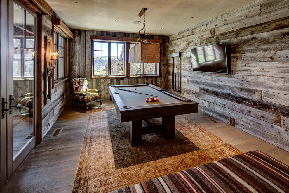 Design ideas for a rustic enclosed games room in Salt Lake City with brown walls, dark hardwood flooring, a wall mounted tv and brown floors.