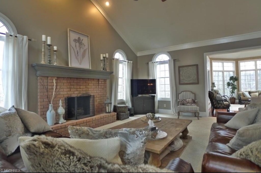Inspiration for a medium sized traditional open plan games room in Cleveland with grey walls, carpet, a standard fireplace, a brick fireplace surround, a corner tv and beige floors.