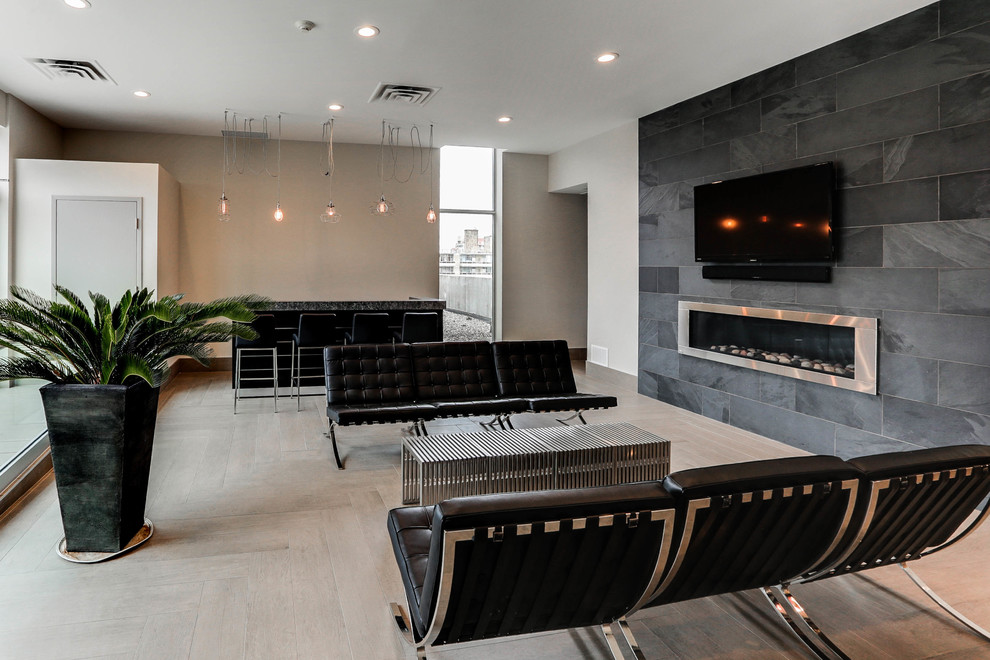 Inspiration for a medium sized industrial mezzanine games room in Toronto with grey walls, a ribbon fireplace, a tiled fireplace surround and a wall mounted tv.
