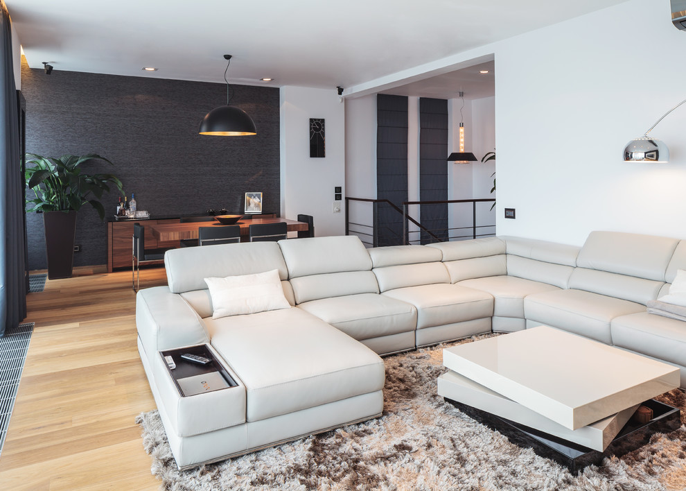 Foto de sala de estar abierta contemporánea con paredes negras y suelo de madera clara