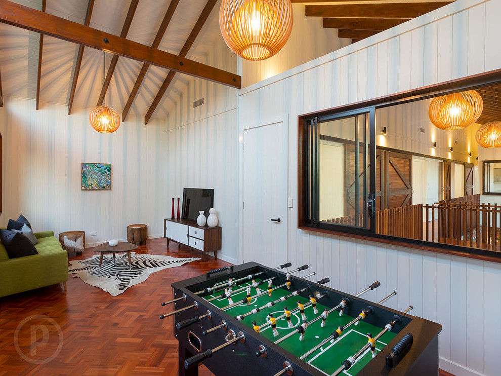 Design ideas for a medium sized urban enclosed games room in Brisbane with a game room, white walls, medium hardwood flooring, no fireplace and a freestanding tv.