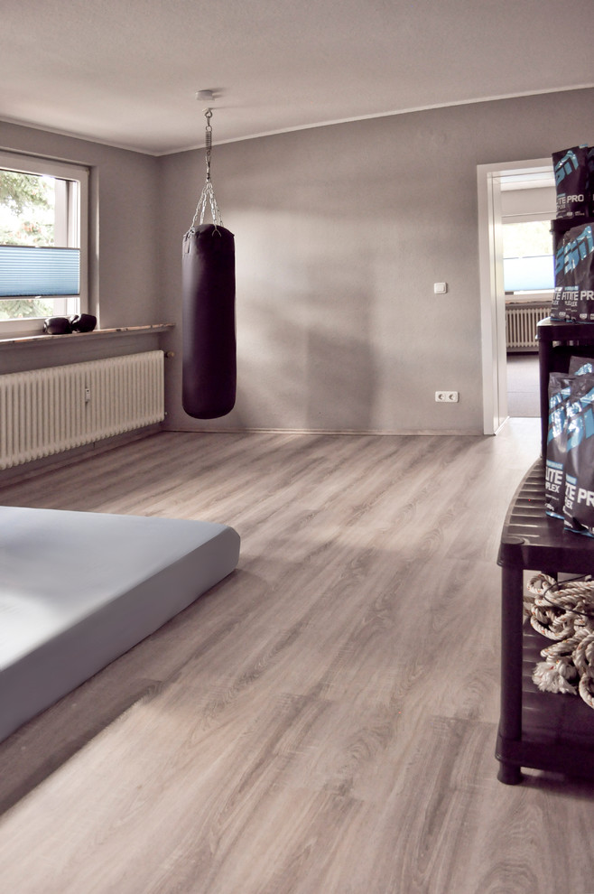 Medium sized urban multi-use home gym in Other with grey walls, laminate floors, grey floors and a wallpapered ceiling.