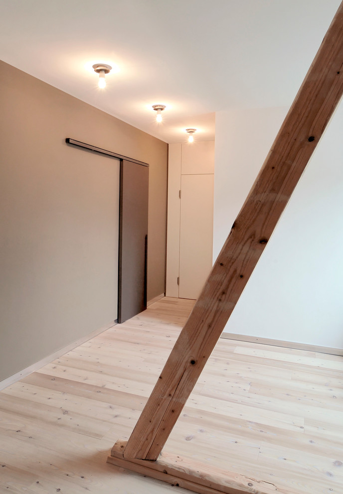 Example of a small danish light wood floor hallway design in Dusseldorf