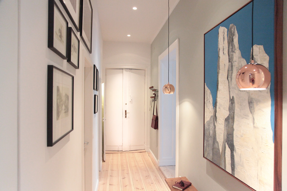 Hallway - large contemporary light wood floor hallway idea in Berlin with gray walls