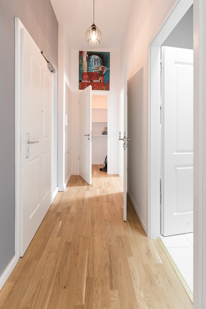 Стильный дизайн: коридор среднего размера в стиле неоклассика (современная классика) с разноцветными стенами и паркетным полом среднего тона - последний тренд