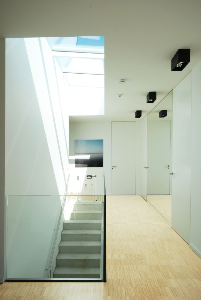 Свежая идея для дизайна: большой коридор в стиле модернизм с белыми стенами, полом из бамбука и бежевым полом - отличное фото интерьера