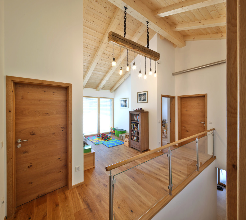 Inspiration for a mid-sized contemporary dark wood floor and brown floor hallway remodel in Munich with white walls