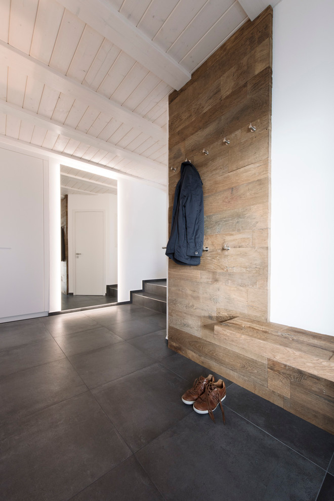Example of a mountain style hallway design in Munich with white walls