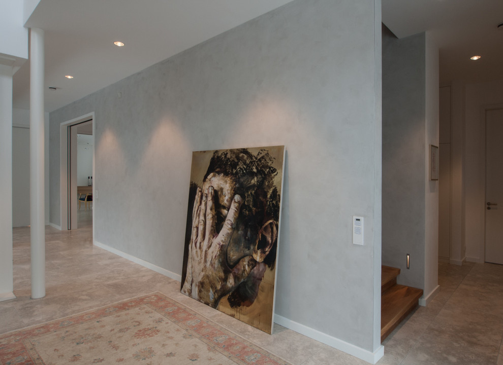 Inspiration for a mid-sized rustic limestone floor hallway remodel in Hamburg with gray walls