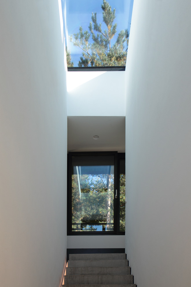 Hallway - huge contemporary concrete floor and gray floor hallway idea in Hanover with white walls