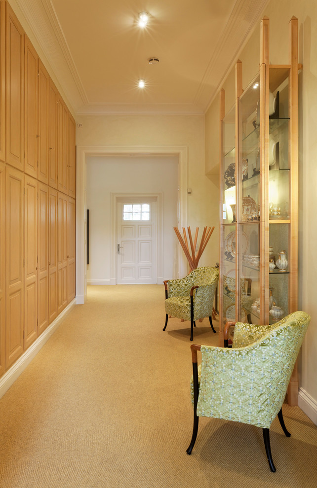 Inspiration for a large timeless carpeted hallway remodel in Hamburg with yellow walls