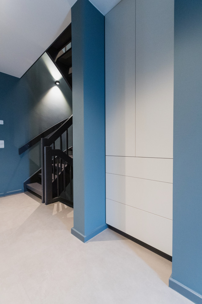Esempio di un ingresso o corridoio minimal di medie dimensioni con pareti blu, pavimento con piastrelle in ceramica e pavimento beige