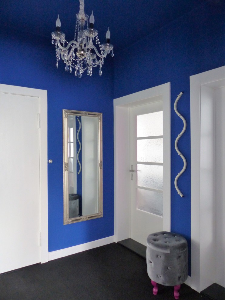 Idéer för små eklektiska hallar, med blå väggar, heltäckningsmatta och svart golv