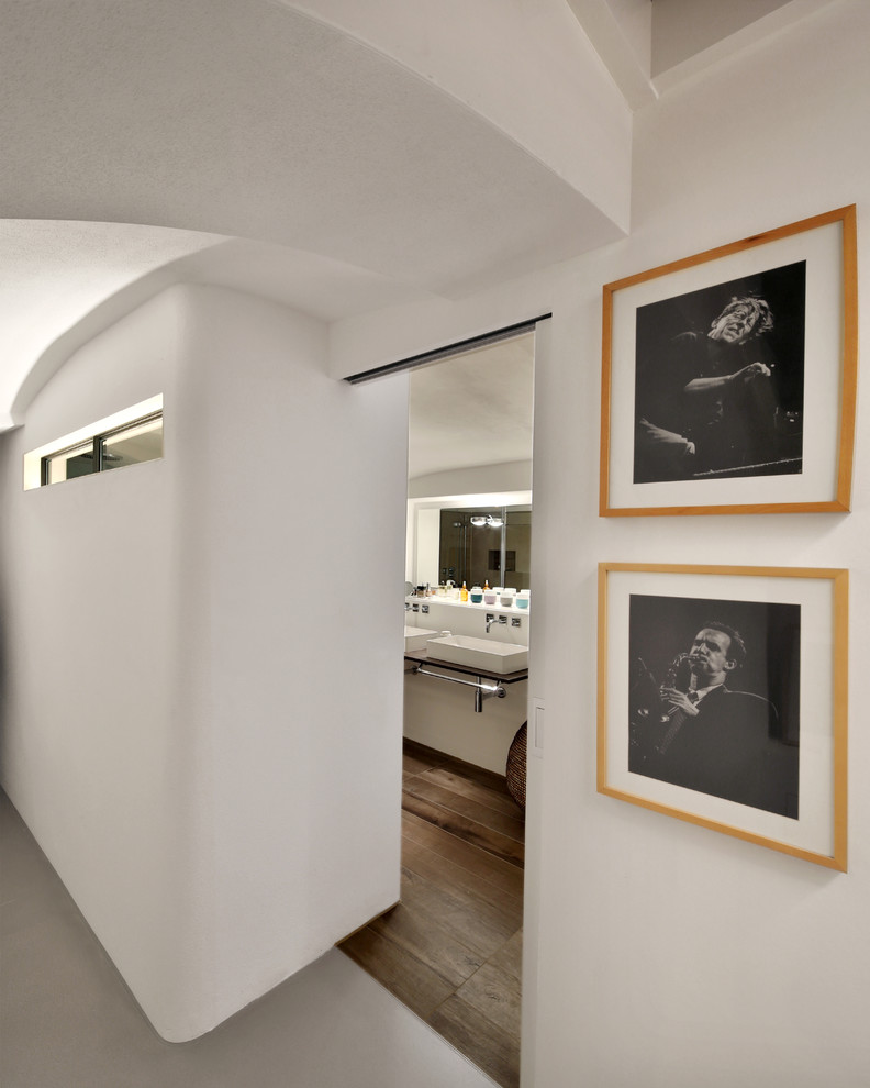 На фото: маленький коридор в стиле модернизм с белыми стенами, бетонным полом и серым полом для на участке и в саду