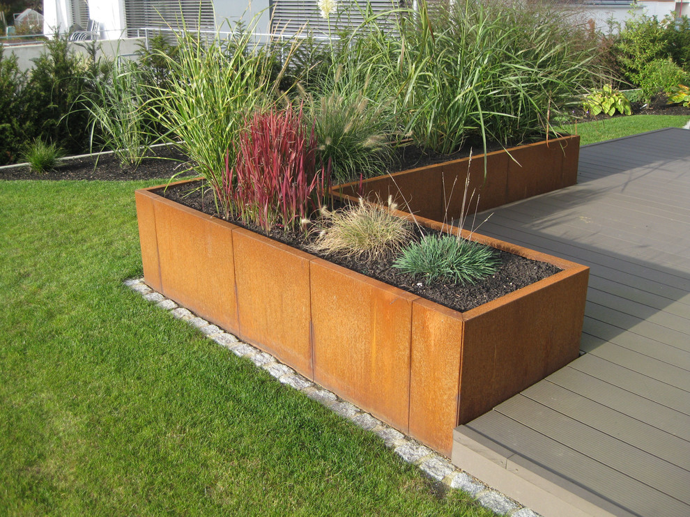 This is an example of a contemporary full sun garden in Other with decking.