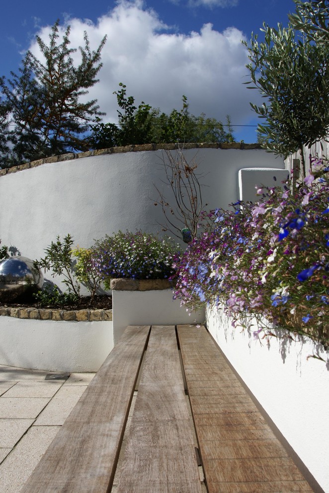 Photo of a contemporary back full sun garden for summer in Dublin with natural stone paving.