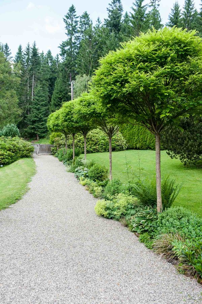 Design ideas for a large farmhouse front driveway full sun garden in Other with a garden path and gravel.