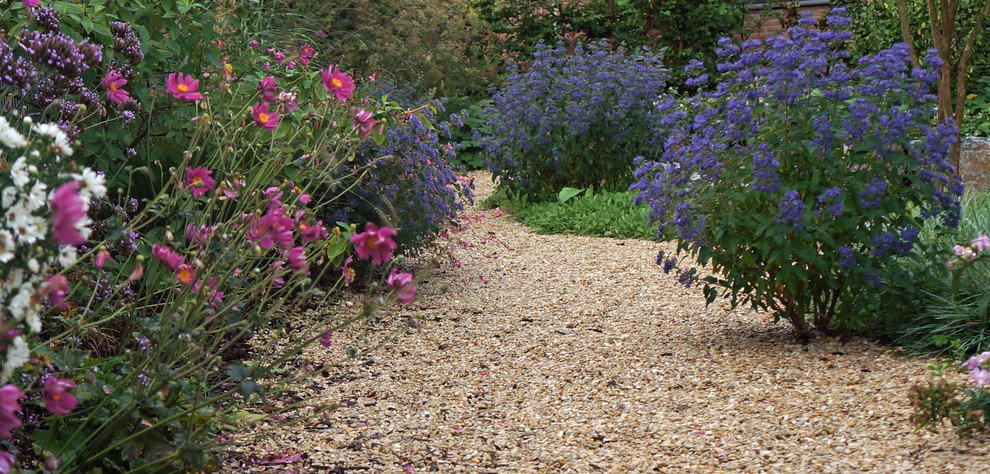 Immagine di un giardino tradizionale con un ingresso o sentiero e pavimentazioni in pietra naturale