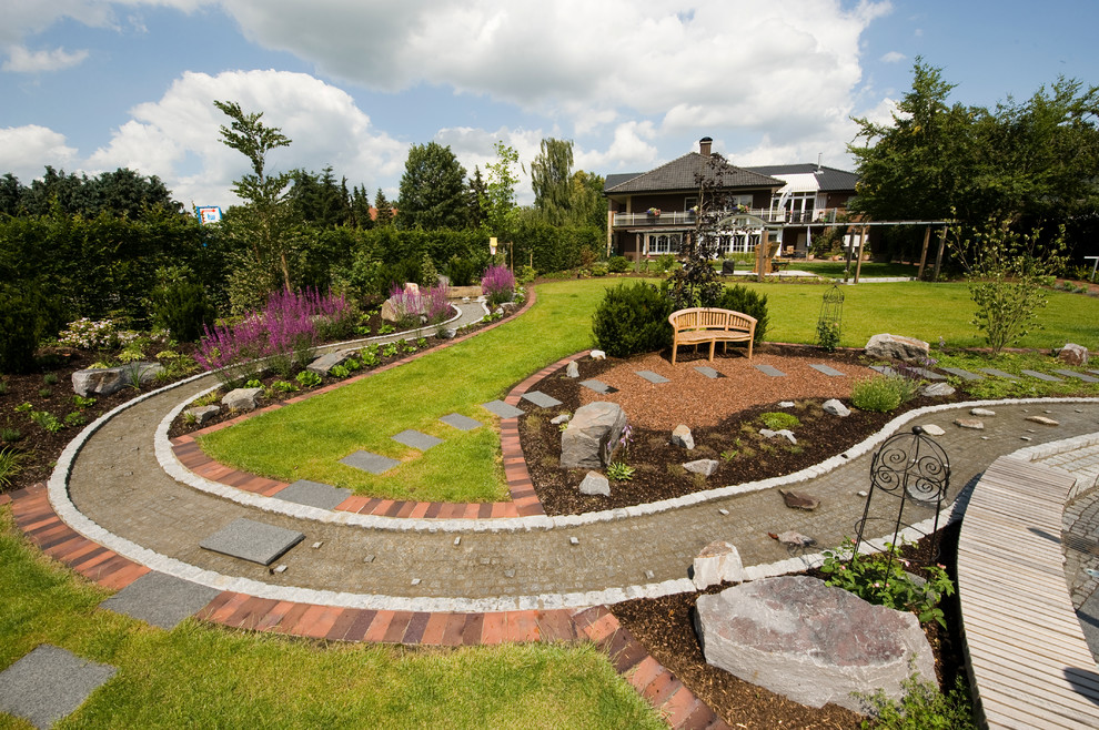 Photo of a huge farmhouse full sun backyard stone garden path in Other for summer.