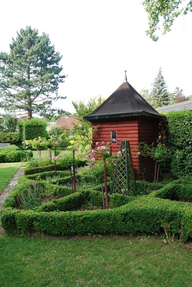 На фото: солнечный участок и сад в викторианском стиле с садовой дорожкой или калиткой, хорошей освещенностью и покрытием из каменной брусчатки