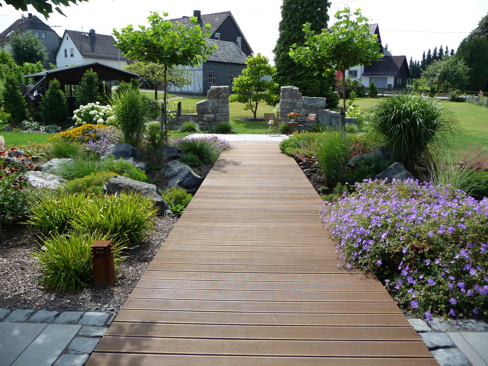 Photo of a large traditional full sun hillside garden path in Frankfurt with decking for summer.