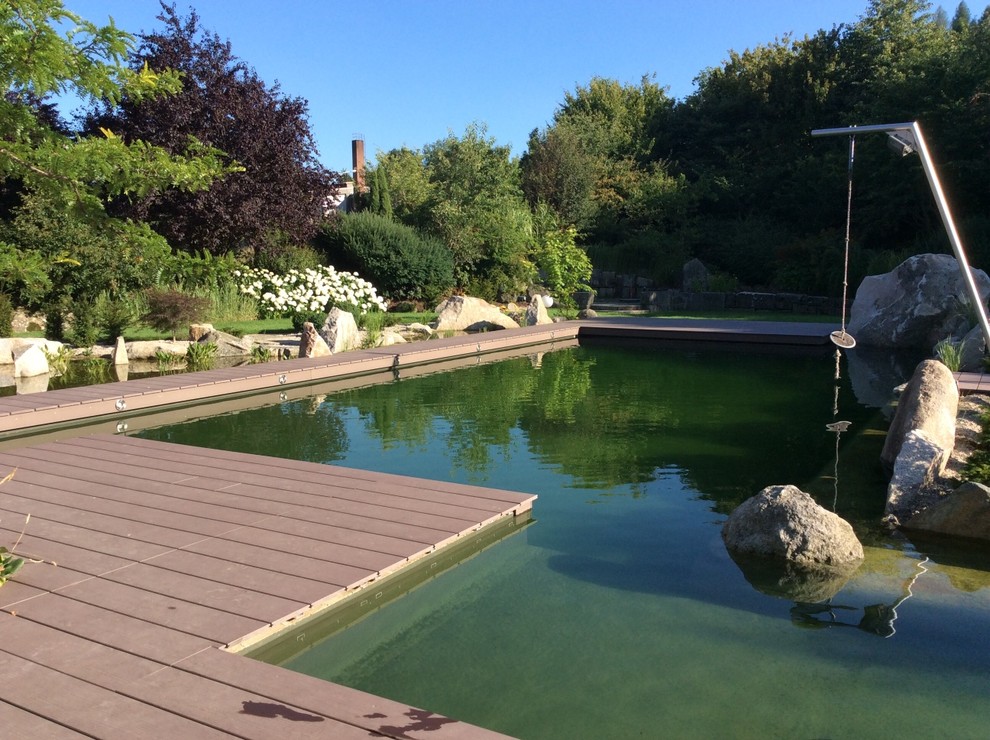 Photo of a huge asian partial sun backyard water fountain landscape in Nuremberg with decking for summer.