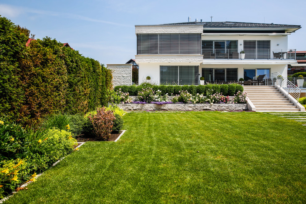 Design ideas for a large contemporary back full sun garden for summer in Stuttgart with a garden path.