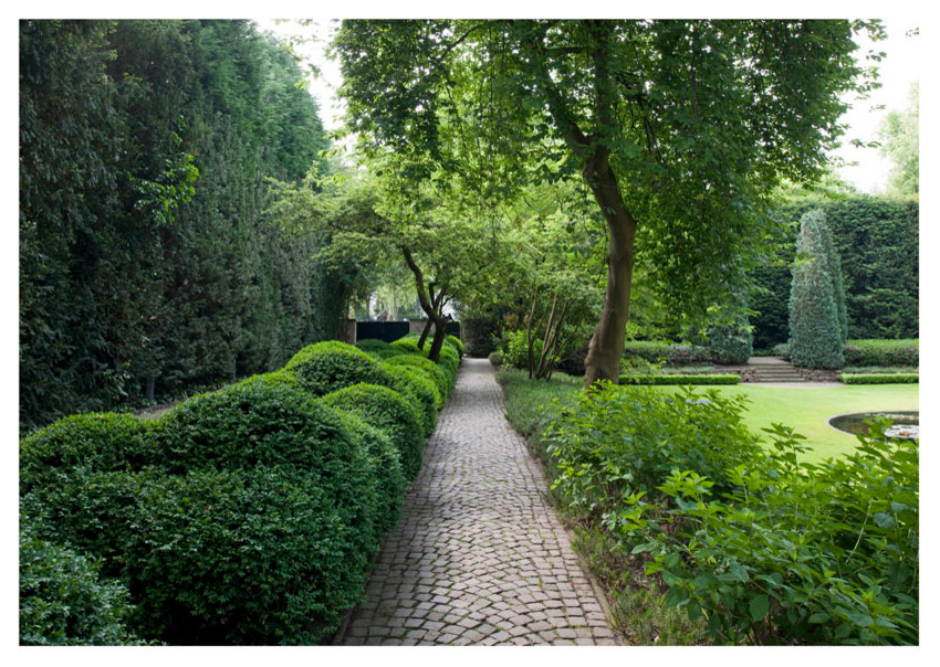 Exemple d'un grand aménagement d'entrée ou allée de jardin chic avec une exposition partiellement ombragée et des pavés en pierre naturelle.