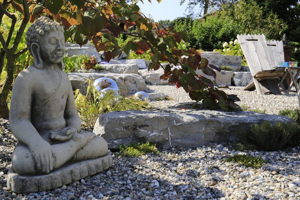 Diseño de jardín asiático de tamaño medio en patio trasero con exposición total al sol, adoquines de piedra natural y brasero