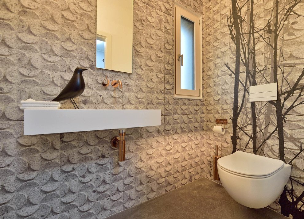 Inspiration pour un petit WC et toilettes design avec WC séparés, un carrelage beige, un lavabo suspendu et un sol marron.