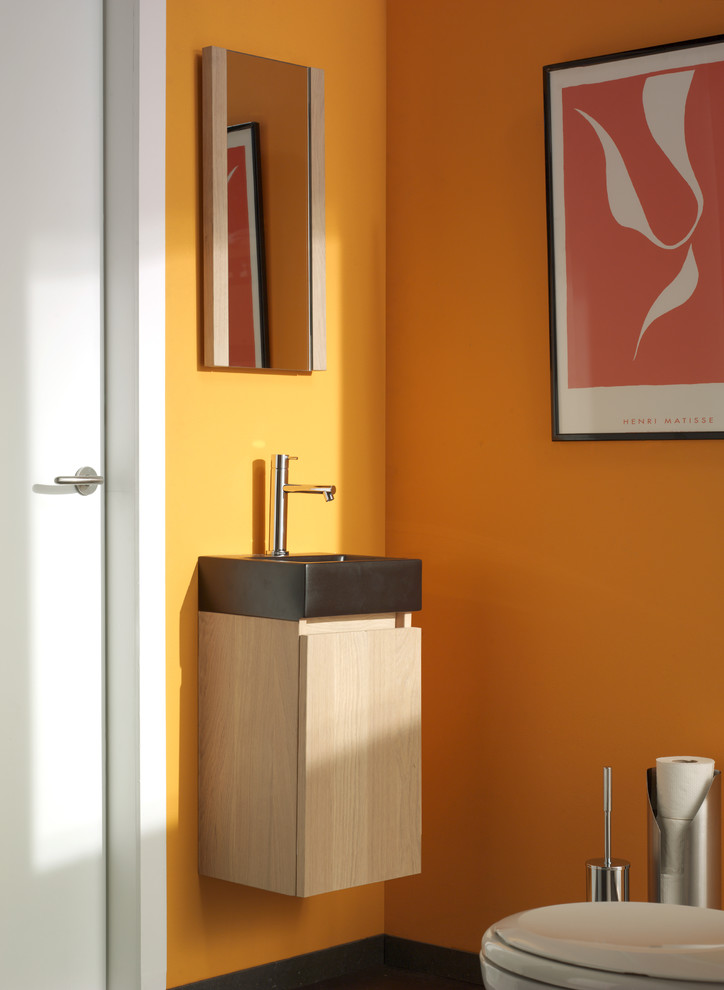 Inspiration pour un WC et toilettes rustique en bois clair avec un placard à porte plane et un mur jaune.
