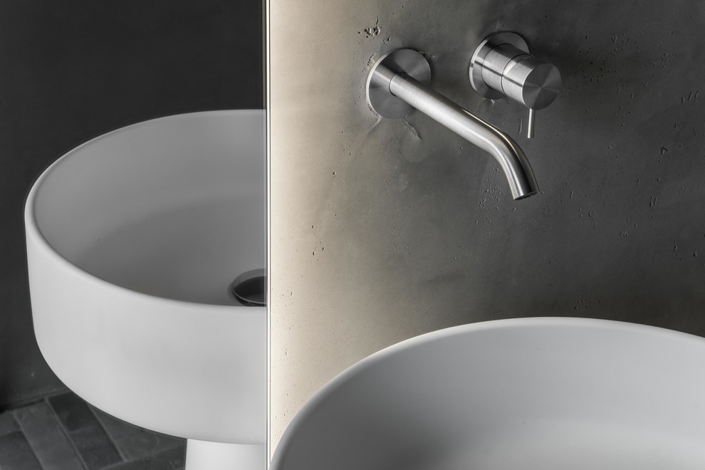 Immagine di un piccolo bagno di servizio minimalista con top in superficie solida