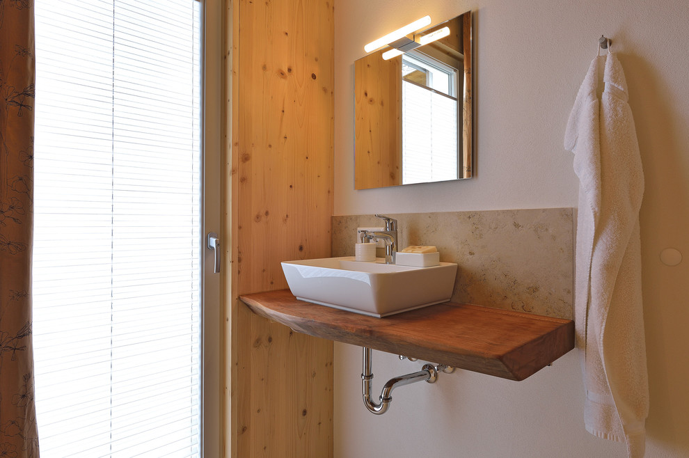 На фото: туалет в скандинавском стиле с разноцветной плиткой и мраморной столешницей