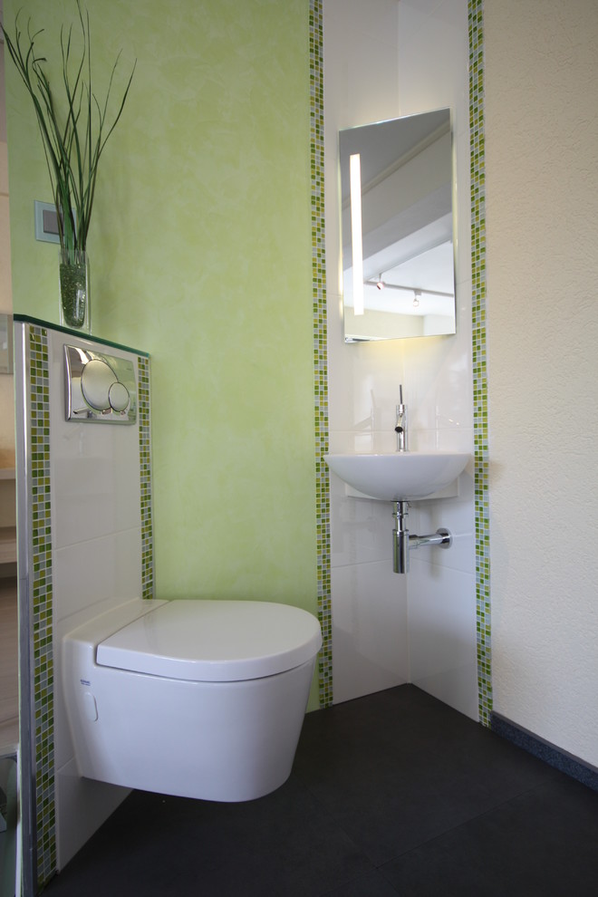 На фото: маленький туалет в современном стиле с раковиной с несколькими смесителями, инсталляцией, белой плиткой, зеленой плиткой, плиткой мозаикой, зелеными стенами и полом из керамогранита для на участке и в саду с