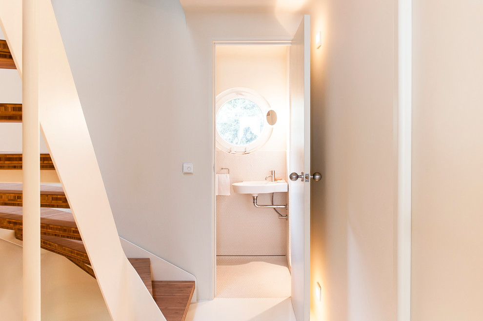 Example of a small eclectic powder room design in Hamburg with white walls