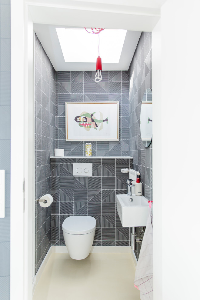 Imagen de aseo urbano pequeño con sanitario de pared, baldosas y/o azulejos blancas y negros, lavabo suspendido, encimera de acrílico y suelo beige