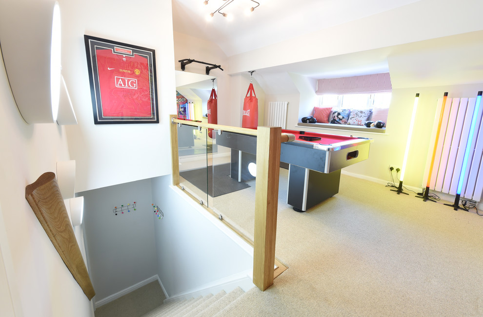 Example of a mid-sized trendy enclosed carpeted game room design in Manchester with gray walls