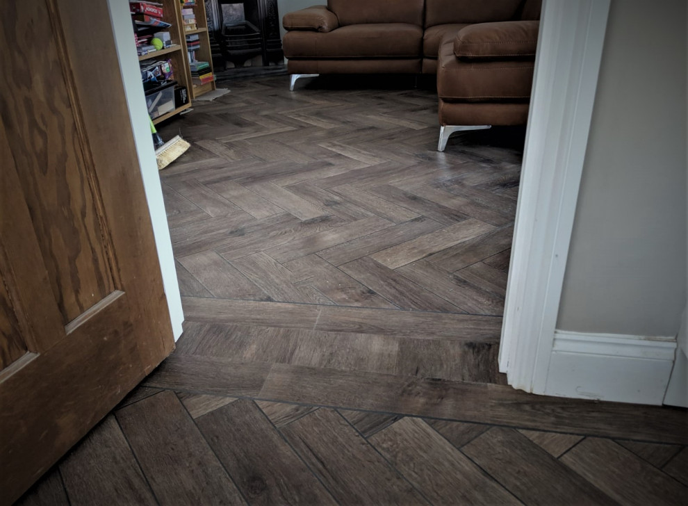 Mountain style vinyl floor and brown floor family room photo in Hertfordshire with gray walls