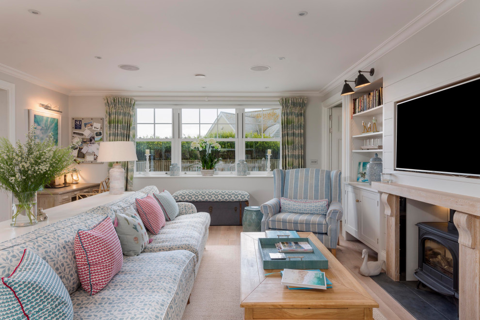 Example of a beach style family room design in Devon