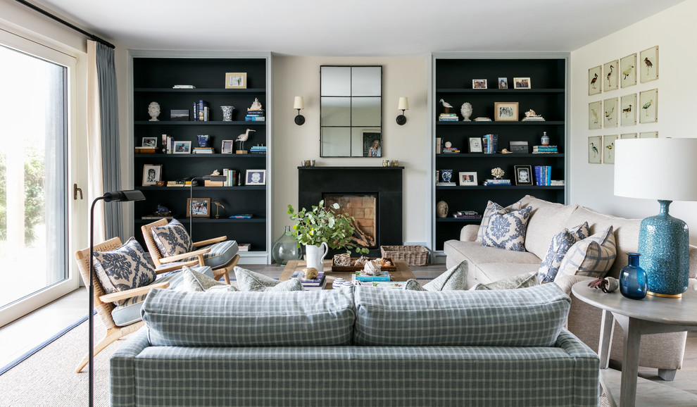 Photo of a large beach style games room in London with beige walls, a standard fireplace and no tv.