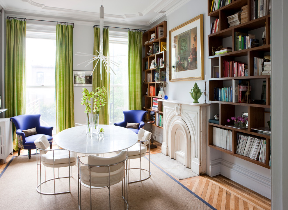 Inspiration for a contemporary enclosed light wood floor family room library remodel in London with white walls, a standard fireplace and no tv