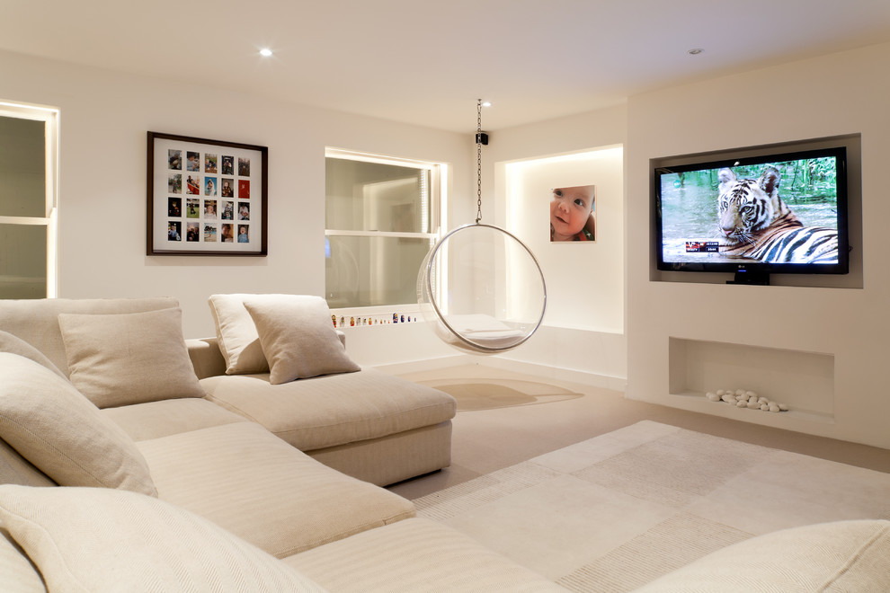 Contemporary enclosed games room in London with beige walls, carpet, a wall mounted tv and beige floors.