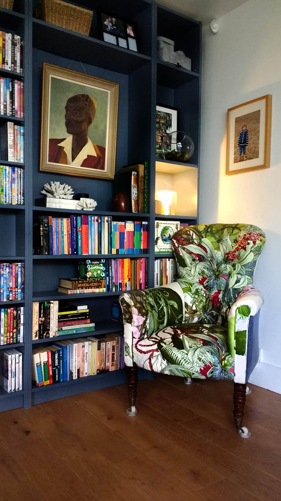 Inspiration for a medium sized eclectic open plan games room in Berkshire with a reading nook, blue walls, medium hardwood flooring, no fireplace and a concealed tv.