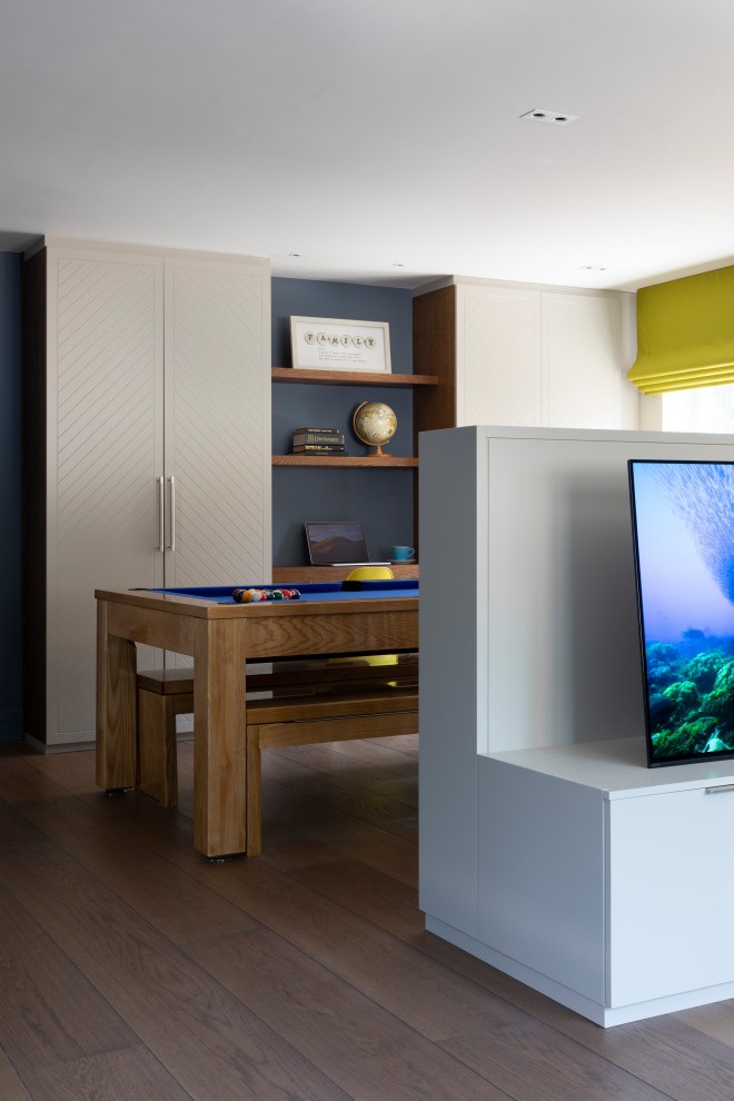 Design ideas for a contemporary games room in Hertfordshire with a game room, blue walls and dark hardwood flooring.