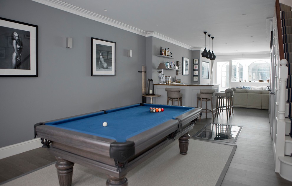 This is an example of a medium sized classic open plan games room in Wiltshire with grey walls, grey floors and light hardwood flooring.