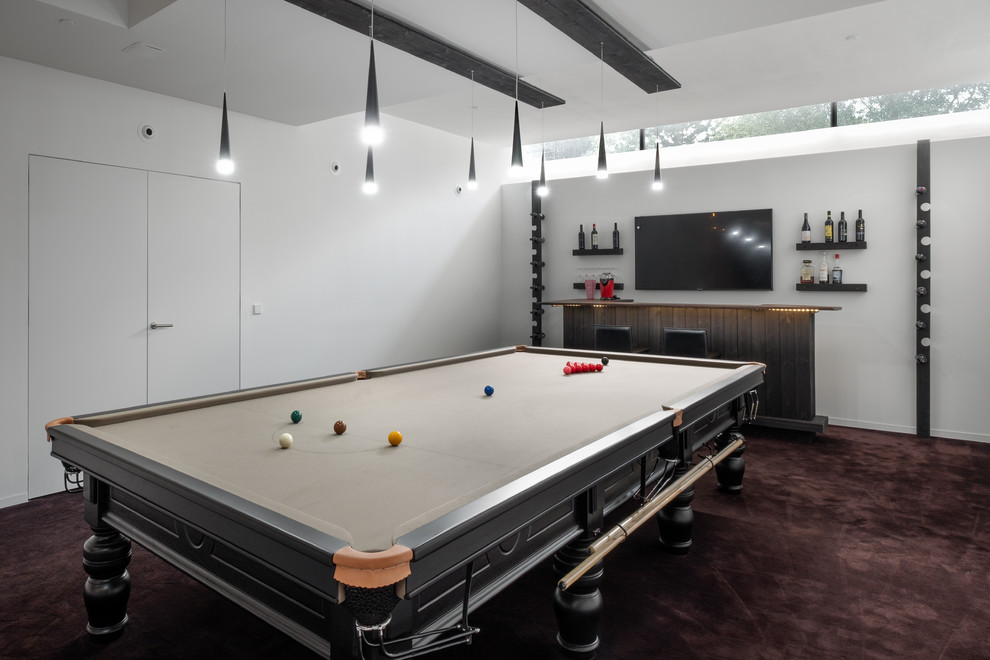 Medium sized contemporary enclosed games room in Gloucestershire with white walls, carpet, a wall mounted tv and brown floors.
