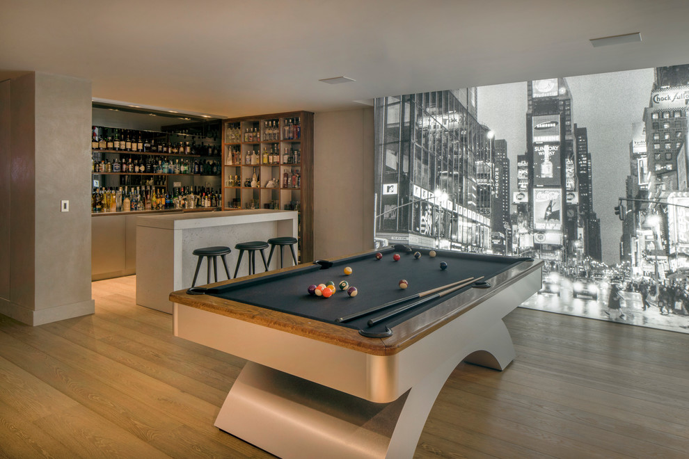 This is an example of a contemporary games room in London with light hardwood flooring and beige floors.