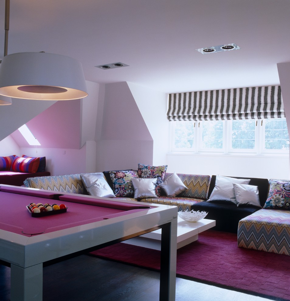 This is an example of a contemporary games room in London with white walls.