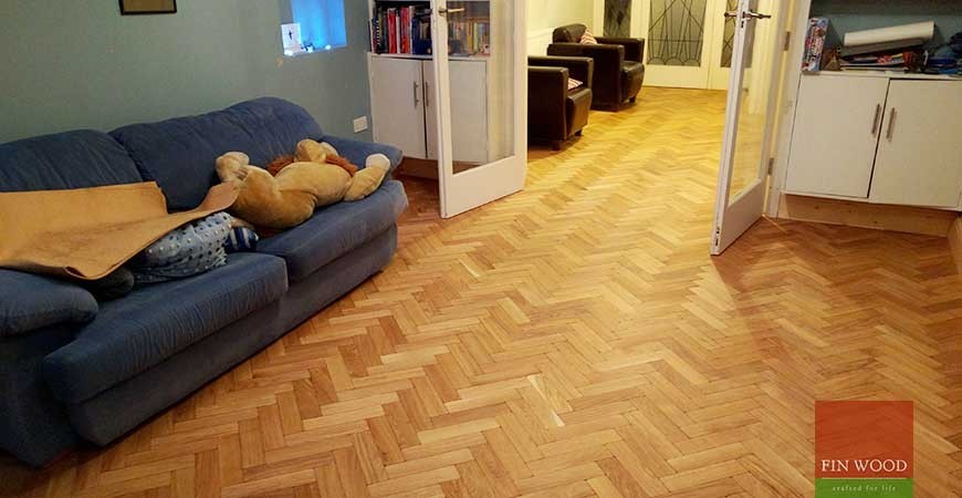 Inspiration for a large retro games room in London with light hardwood flooring.