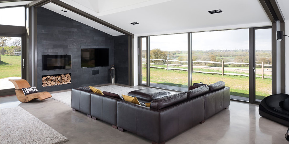 Idee per un soggiorno design chiuso con pareti grigie e parete attrezzata